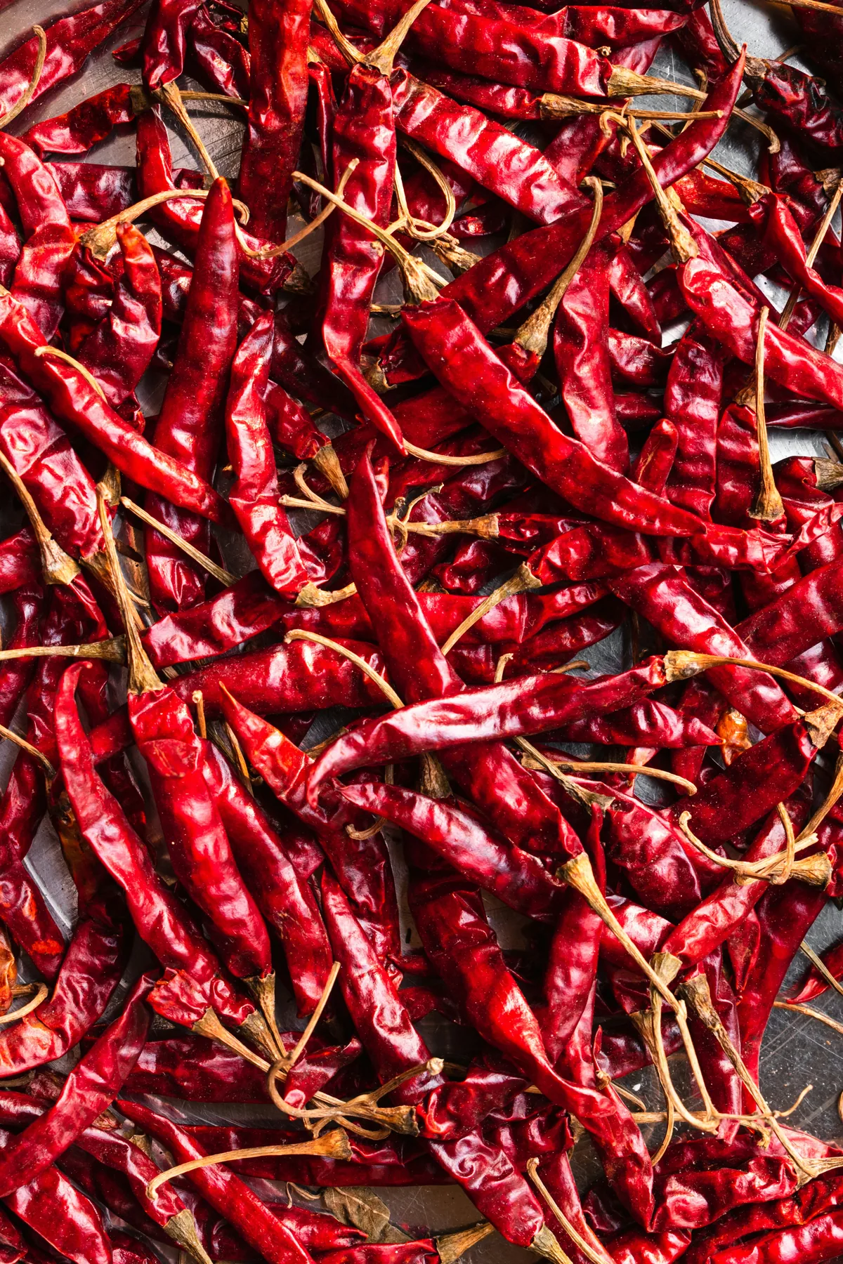 A pile of sun-dried red chillies, illustrating traditional open-air drying