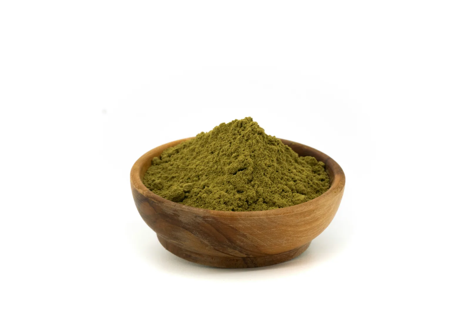 A wooden bowl filled with fine green herbal powder
