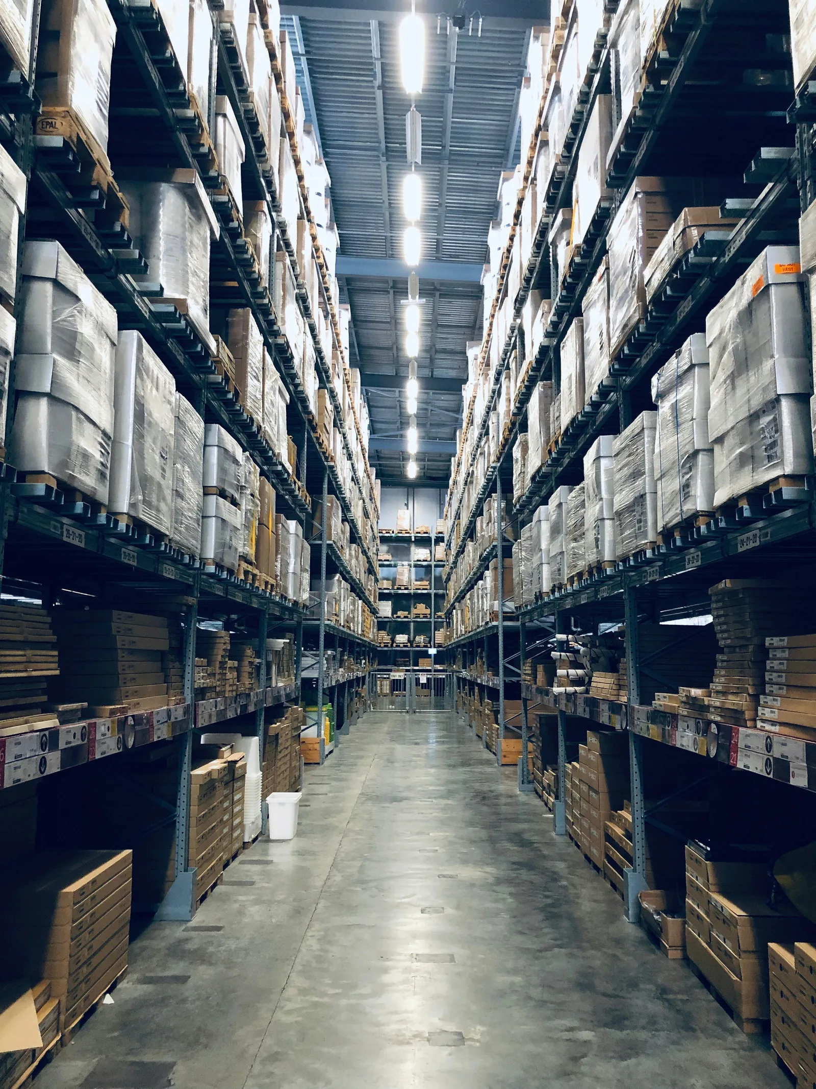 Warehouse shelving stacked with packaged goods, representing bulk and private label supply